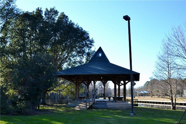 view of home's community featuring a gazebo, a yard, and a water view