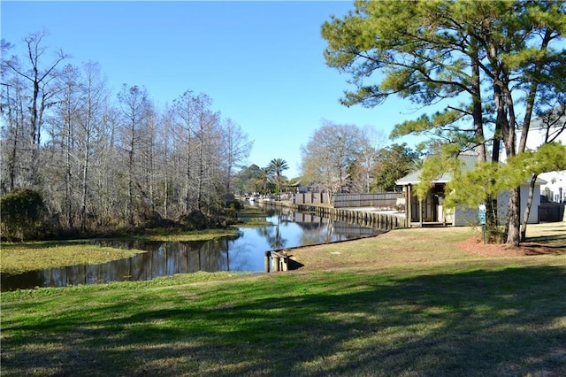 exterior space with a lawn and a water view