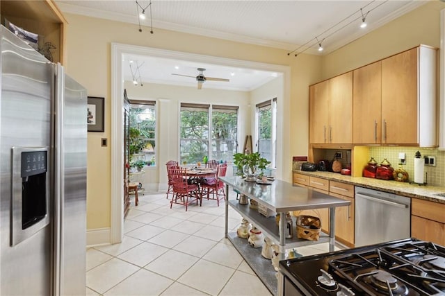 kitchen with backsplash, ceiling fan, light tile patterned flooring, light stone counters, and stainless steel appliances