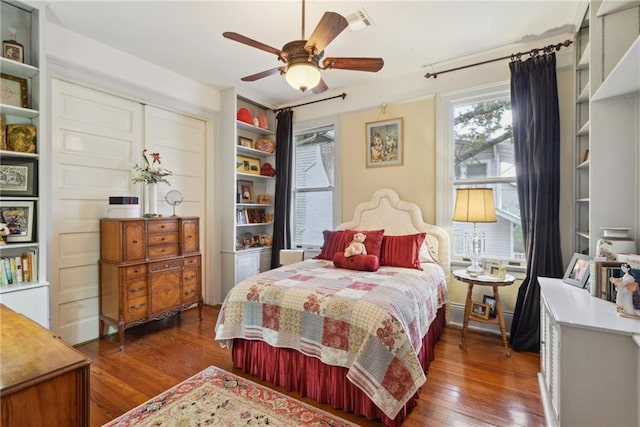 bedroom with ceiling fan and dark wood-type flooring