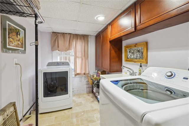 washroom featuring cabinets, separate washer and dryer, light tile patterned flooring, and sink