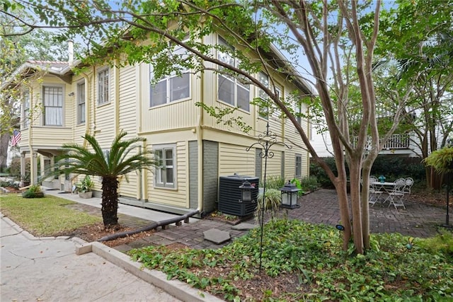 view of home's exterior featuring cooling unit and a patio area