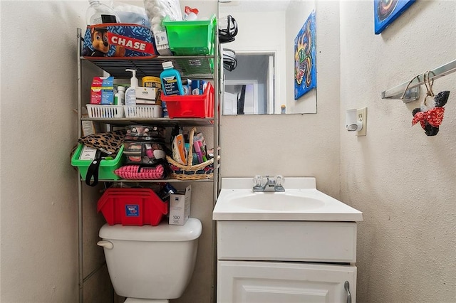 bathroom with toilet and vanity