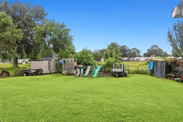 view of yard featuring a playground and a shed