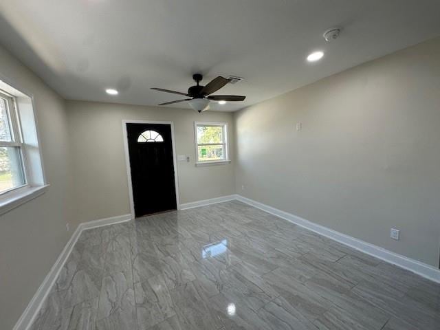 foyer entrance featuring ceiling fan