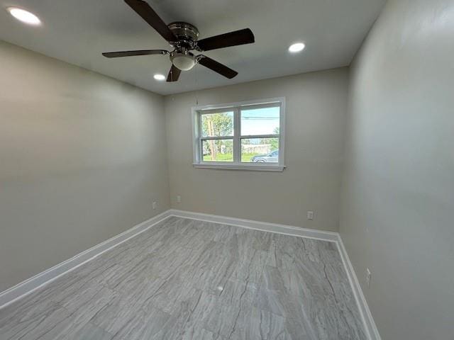 spare room with light wood-type flooring and ceiling fan