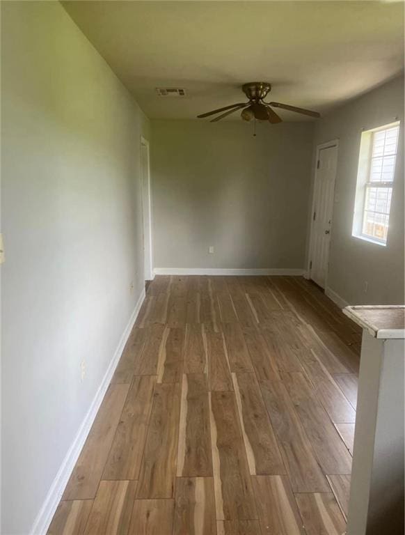 spare room featuring ceiling fan and wood-type flooring