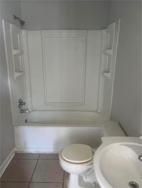 full bathroom featuring tile patterned floors, shower / bathtub combination, toilet, and sink