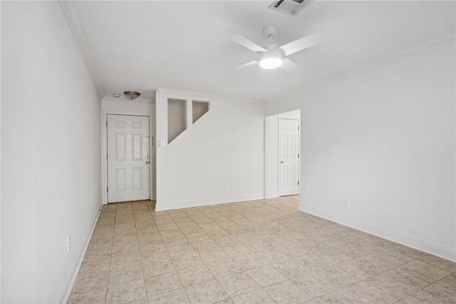 empty room featuring ceiling fan and crown molding