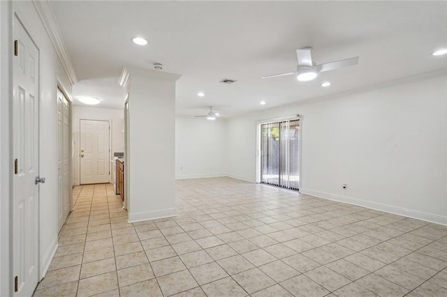 spare room featuring ceiling fan, light tile patterned floors, and ornamental molding