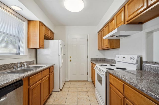 kitchen featuring sink, light tile patterned floors, and white appliances