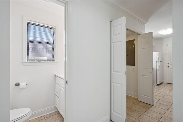 bathroom with ornamental molding, vanity, tile patterned flooring, electric panel, and toilet