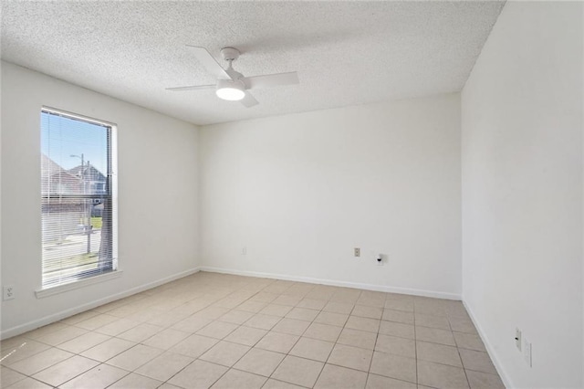 spare room featuring light tile patterned floors, a textured ceiling, and ceiling fan