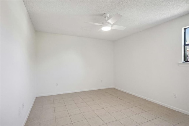 tiled spare room with a textured ceiling and ceiling fan