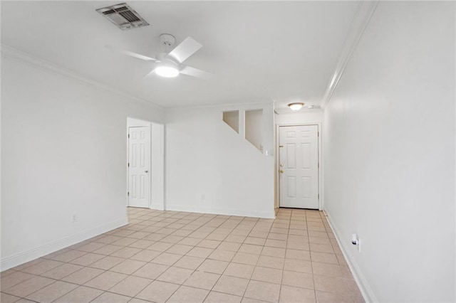 tiled spare room with ceiling fan and ornamental molding