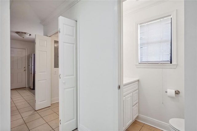 bathroom with tile patterned floors, toilet, vanity, and ornamental molding