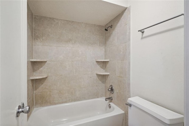 bathroom featuring a textured ceiling, tiled shower / bath combo, and toilet