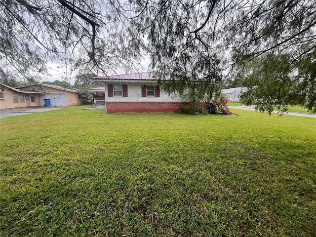 view of front of home with a garage and a front lawn