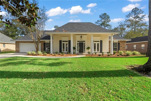 view of front of home with french doors, covered porch, a front yard, and a garage