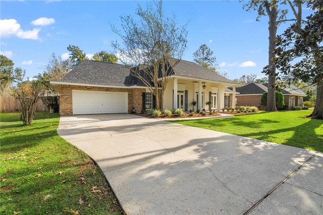 view of front of home featuring a front yard and a garage