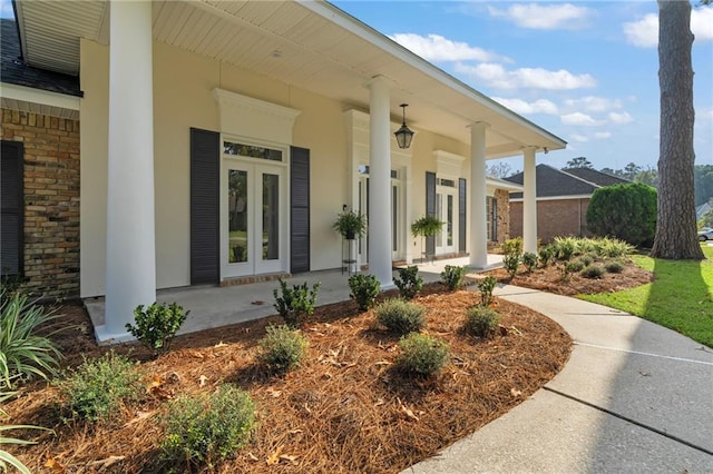 property entrance featuring french doors and a porch