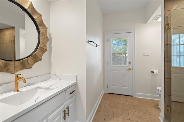 bathroom featuring tile patterned flooring, vanity, toilet, and walk in shower