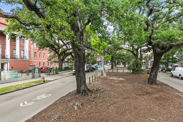 view of road with sidewalks and curbs