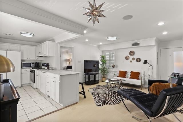 kitchen featuring a breakfast bar, white appliances, white cabinets, ornamental molding, and light tile patterned floors