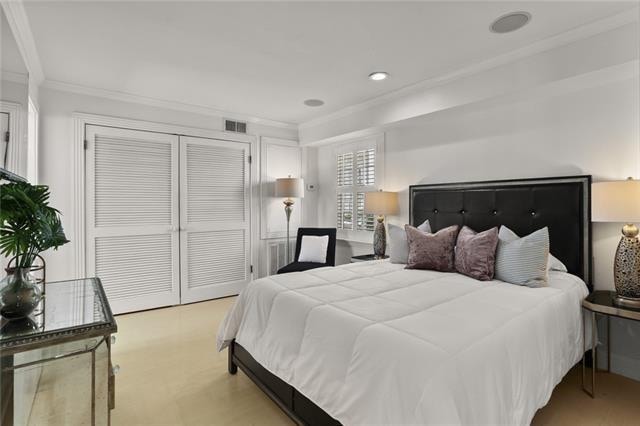 bedroom with a closet and crown molding