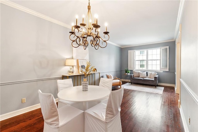 dining room with dark hardwood / wood-style flooring, crown molding, and a chandelier