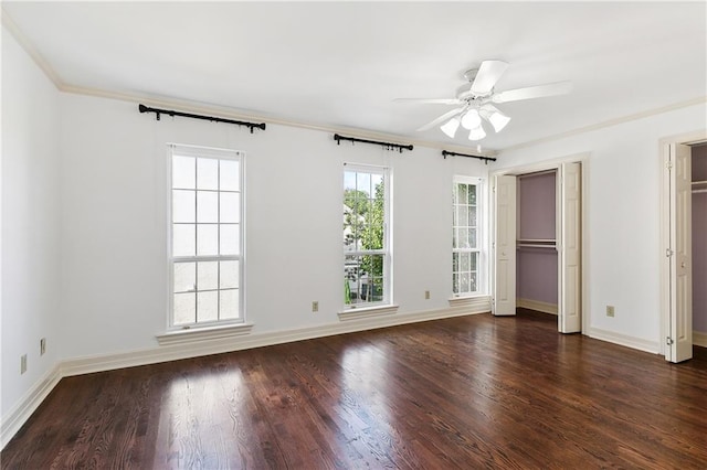 unfurnished bedroom featuring ceiling fan, crown molding, and dark wood-type flooring