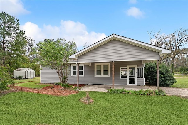 back of property featuring a lawn, a porch, and a shed