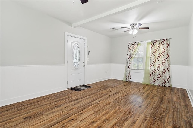 foyer entrance featuring ceiling fan, beamed ceiling, and wood-type flooring