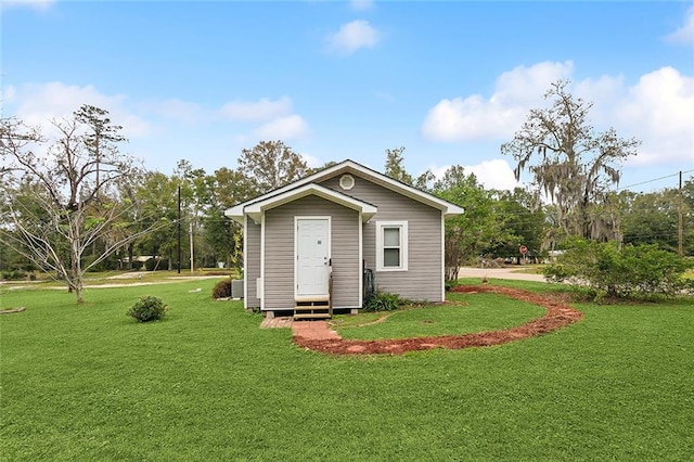 view of outbuilding featuring a lawn