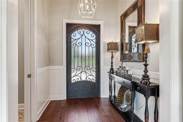 entryway with dark hardwood / wood-style floors and a chandelier