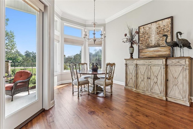 dining area featuring crown molding, a notable chandelier, and dark hardwood / wood-style flooring