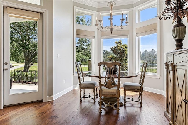 dining area featuring an inviting chandelier, dark hardwood / wood-style flooring, and a healthy amount of sunlight