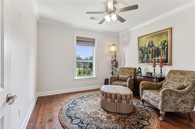 living area with crown molding, hardwood / wood-style flooring, and ceiling fan