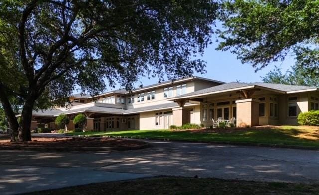 prairie-style home featuring a front lawn