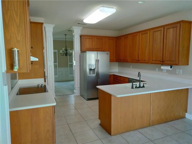 kitchen featuring black electric stovetop, kitchen peninsula, stainless steel refrigerator with ice dispenser, sink, and an inviting chandelier