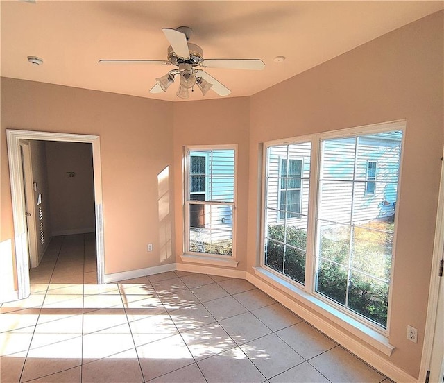 unfurnished room featuring ceiling fan and light tile patterned floors