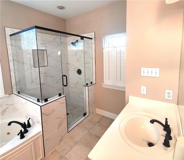 full bathroom featuring a whirlpool tub, a sink, a marble finish shower, and baseboards