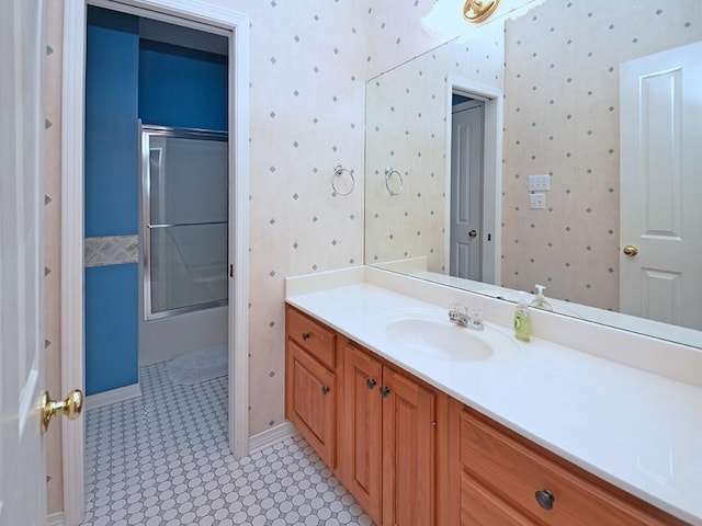 full bath with vanity and combined bath / shower with glass door