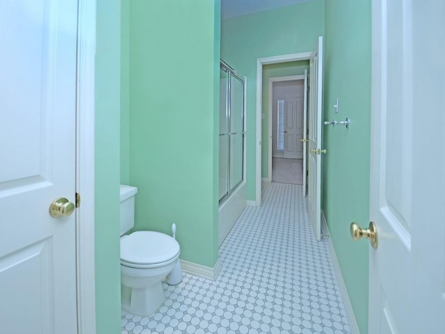 bathroom with baseboards and toilet