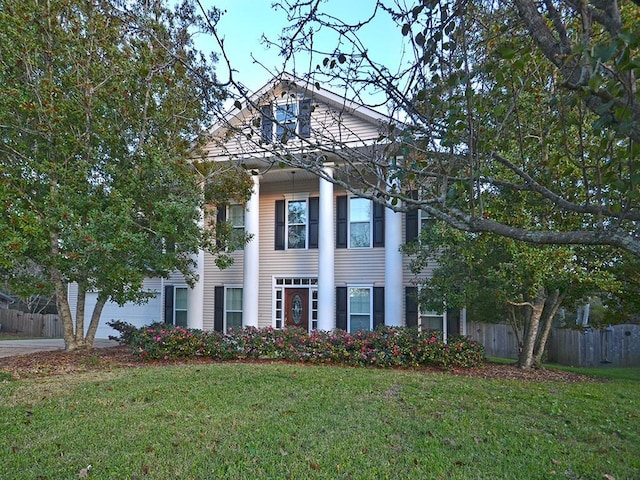 greek revival inspired property featuring fence and a front yard
