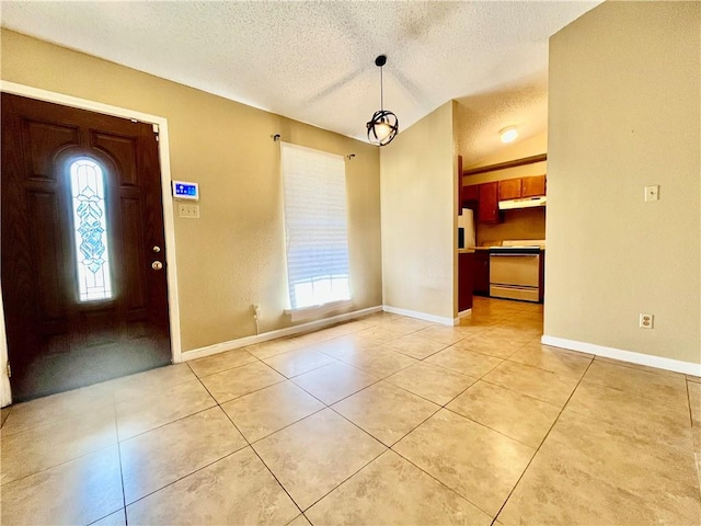 tiled foyer featuring a textured ceiling