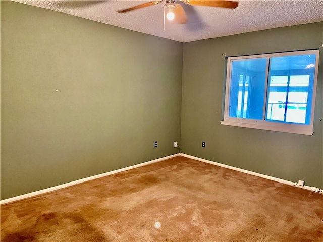 carpeted empty room featuring ceiling fan and a textured ceiling