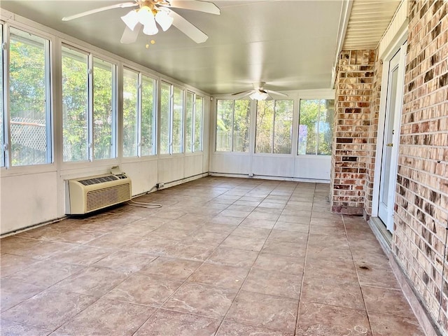 unfurnished sunroom featuring a wall mounted air conditioner and ceiling fan