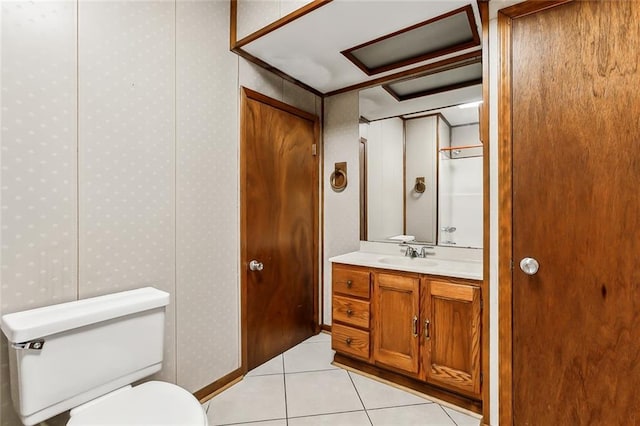 bathroom featuring tile patterned flooring, vanity, and toilet