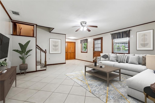 living room featuring ceiling fan, light tile patterned flooring, and ornamental molding